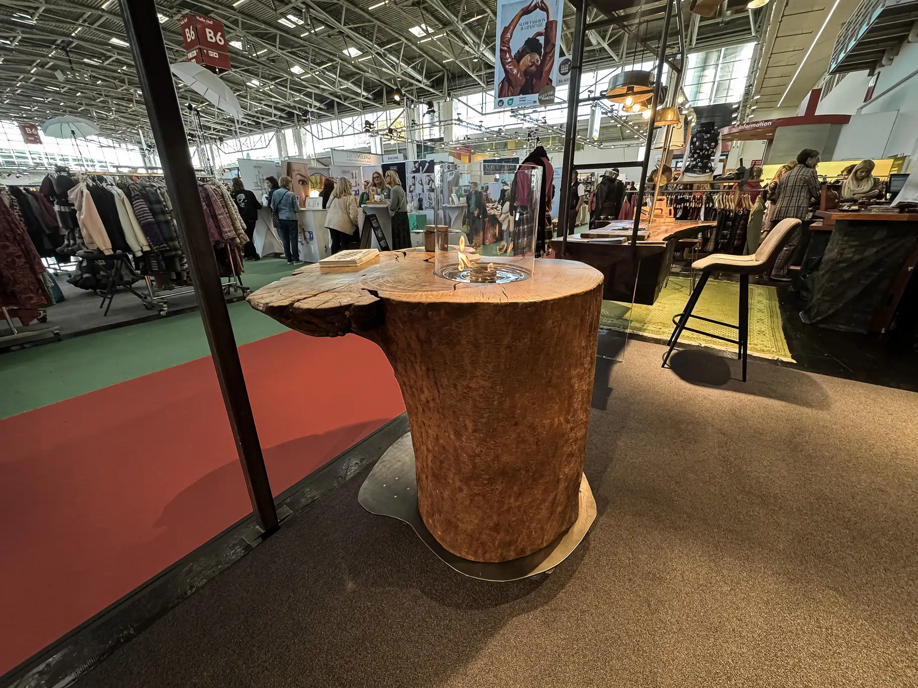 Standing table made from a whole ash trunk with natural live edge and integrated fire section
