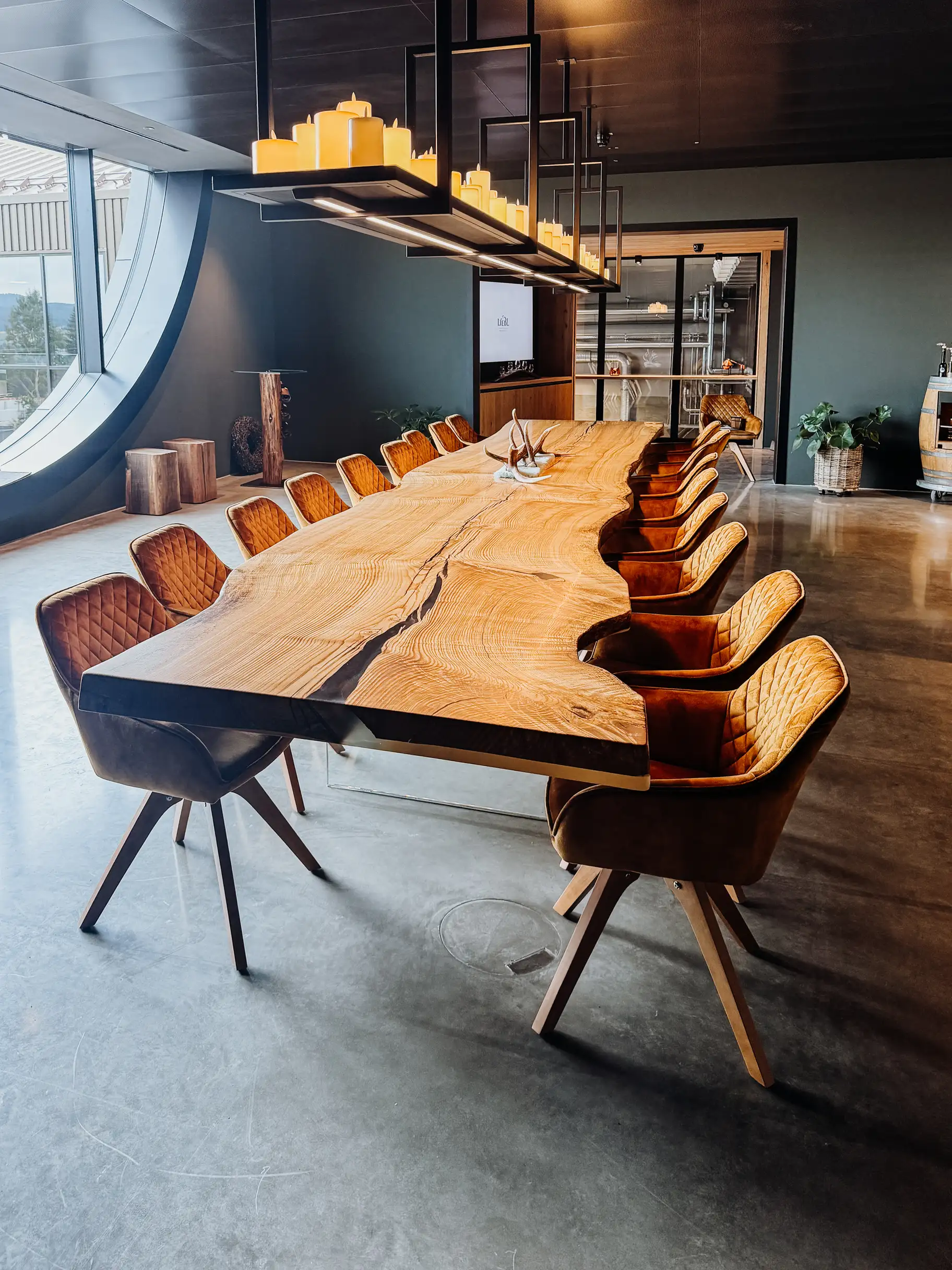 Handcrafted ash live-edge table with natural wood character and glass base for office or dining area