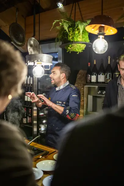 Tommy Eder gives an explanation during a cooking event