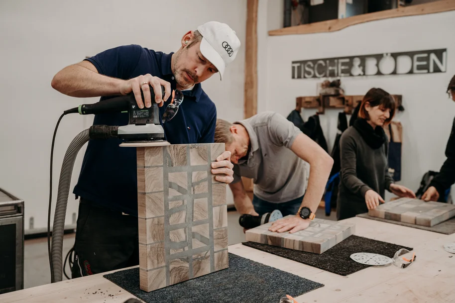Man sanding cutting board in the workshop