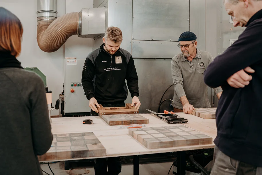 Participants working with wood and epoxy resin in the workshop