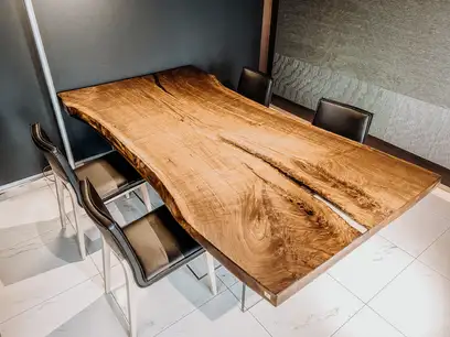 Modern office desk with natural live edge from a walnut tree trunk by Stammdesign.
