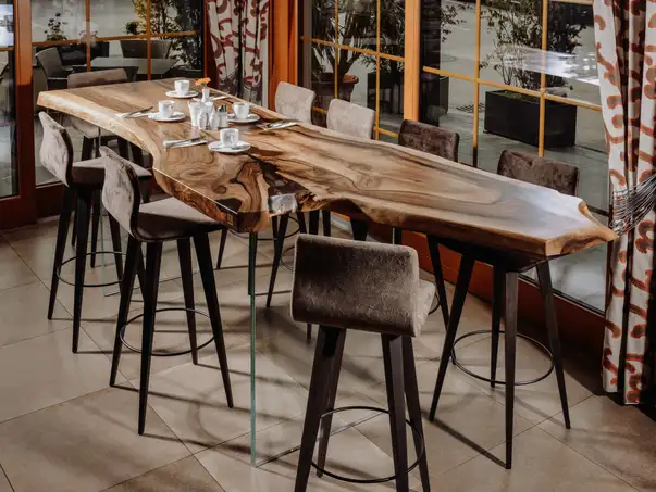 Tavolo da stand realizzato con un tronco d'albero da Stammdesign per la gastronomia in legno massello.