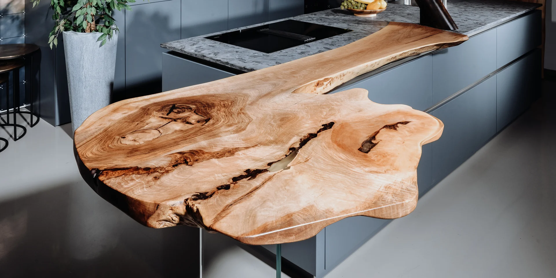 Solid kitchen bar top made from a tree trunk with a sturdy solid wood surface, side view 1.