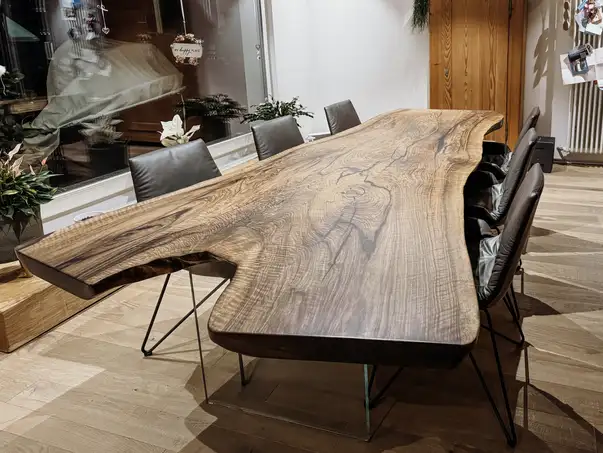 Tavolo in legno massello realizzato con un tronco, con una struttura del legno distintiva e gambe in vetro di noce