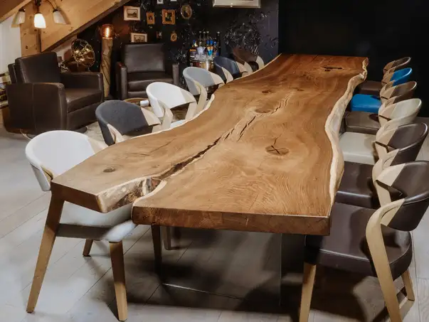 Tavolo massiccio da designer da un tronco con gambe in vetro eleganti e piano robusto in quercia, vista frontale.