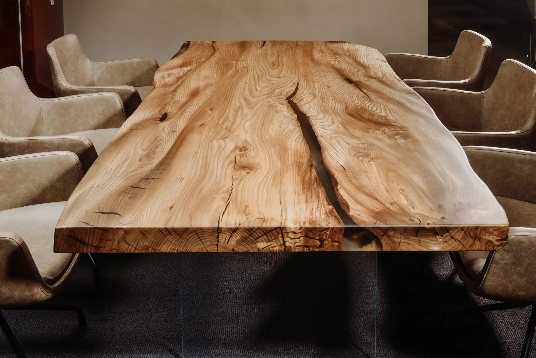 Designer living room table from a tree trunk with a noble live edge, handcrafted from elm, front view.