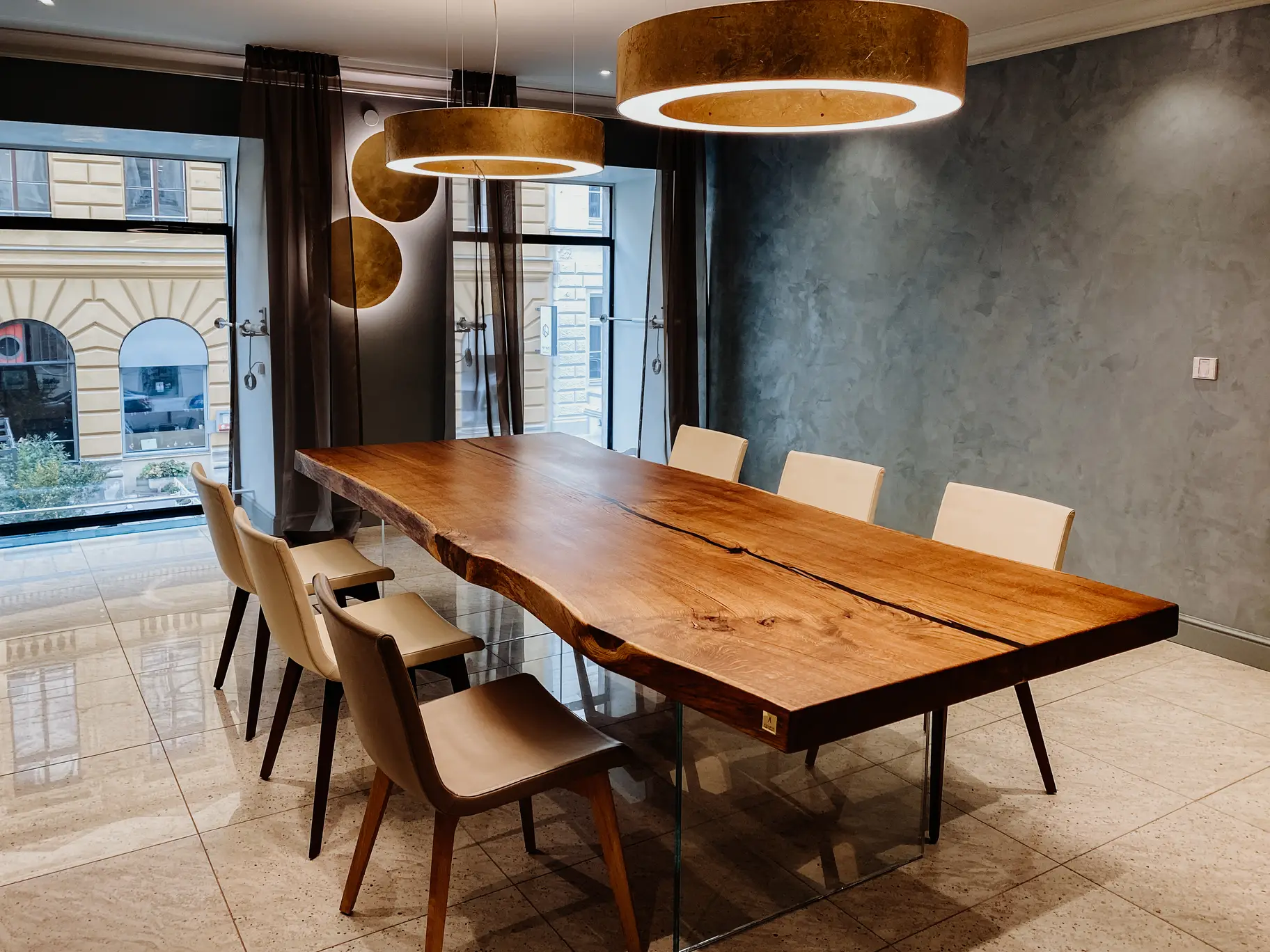 Table design moderne en tronc d’arbre avec pieds en verre et plateau en bois massif de chêne.